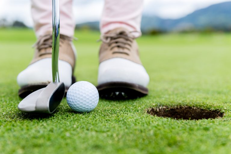 A golfer preparing to take a putt at Kissing Camels Golf Course